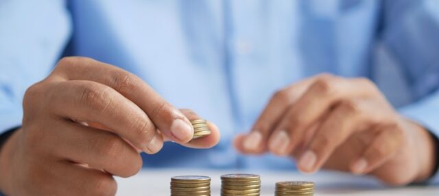 A person stacking coins