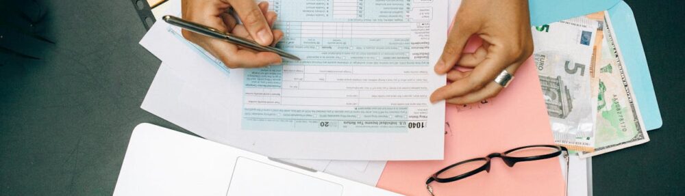 Person writing on a piece of document